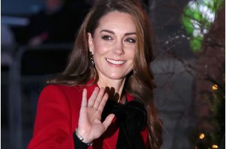Kate Middleton adds holiday flair to previous ensemble for special Christmas carol event.