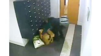 A woman boldly takes Amazon packages from apartment building.