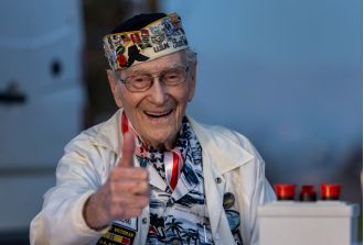 A 100-year-old survivor honors Pearl Harbor Remembrance Day through photos.