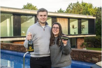 The youngest Omaze winner ever, who won a £3,000,000 house, celebrates with a McDonald's meal.