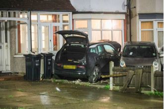 A woman in her 60s died when her car collided with a house.