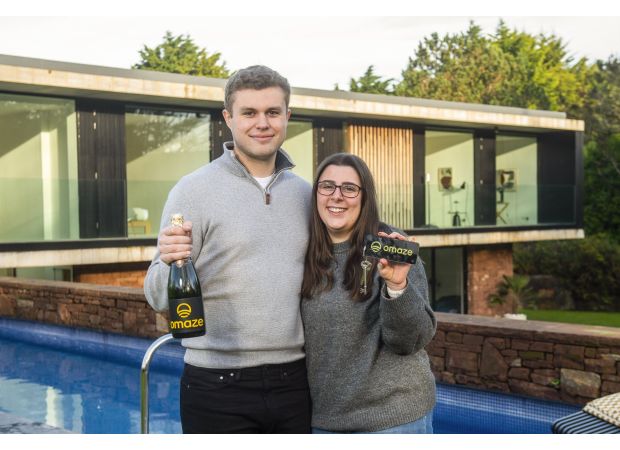 The youngest Omaze winner ever, who won a £3,000,000 house, celebrates with a McDonald's meal.