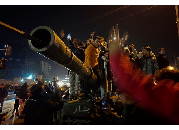 Syrians rejoice and shoot in the air to mark the downfall of the Assad family's 50-year reign.