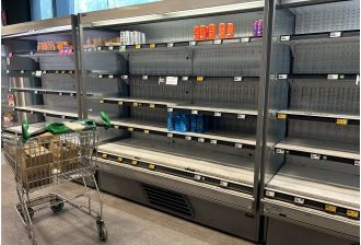 Woolworths employees are rushing to replenish store shelves in preparation for the holiday season.