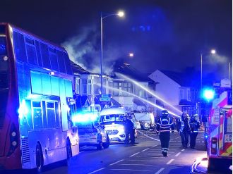 London bus barely escapes being destroyed by a house explosion.