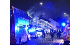 London bus barely escapes being destroyed by a house explosion.
