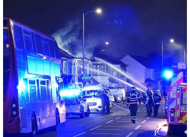 London bus barely escapes being destroyed by a house explosion.