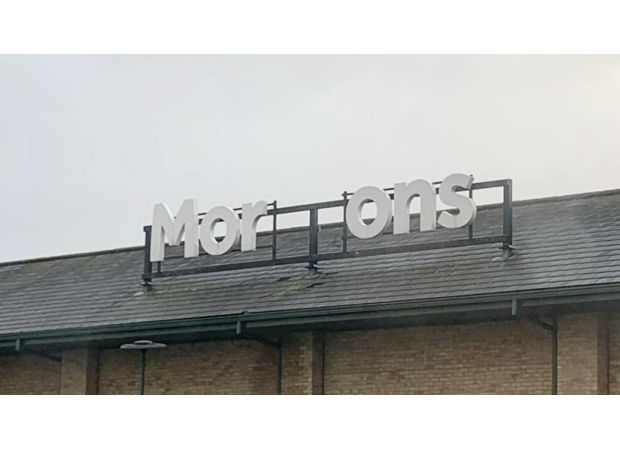 Morrisons is trying to fix their sign after a storm caused damage.