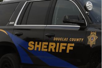 A worker for the Douglas County sheriff is charged with having an improper connection with a prisoner.
