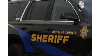 A worker for the Douglas County sheriff is charged with having an improper connection with a prisoner.