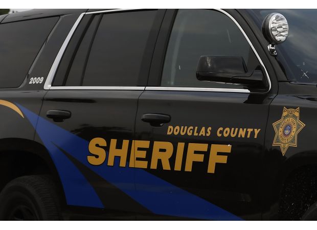A worker for the Douglas County sheriff is charged with having an improper connection with a prisoner.