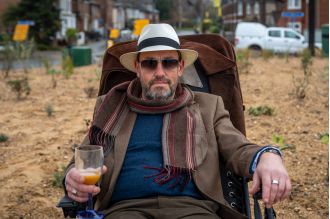 Man enjoys beach-like experience at newly renovated roundabout.