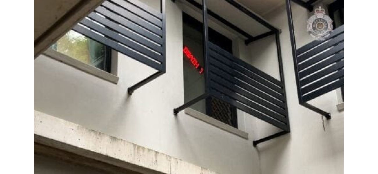 A man from Brisbane accused of displaying a racist sign in his window has been charged.