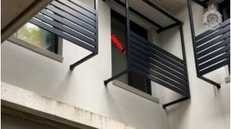 A man from Brisbane accused of displaying a racist sign in his window has been charged.