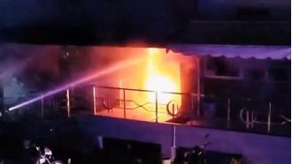 Seven people die in hospital elevator after massive fire engulfs building.