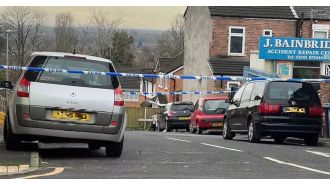 A primary school is on lockdown as a man in his 40s was stabbed and the attacker is still at large.