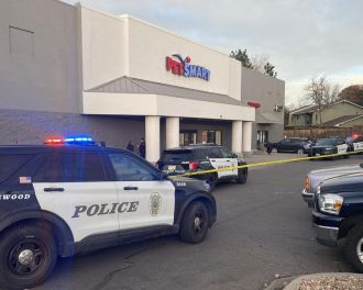 Police apprehend one young and one older suspect in connection with a shooting at a PetSmart store in Lakewood on Friday.