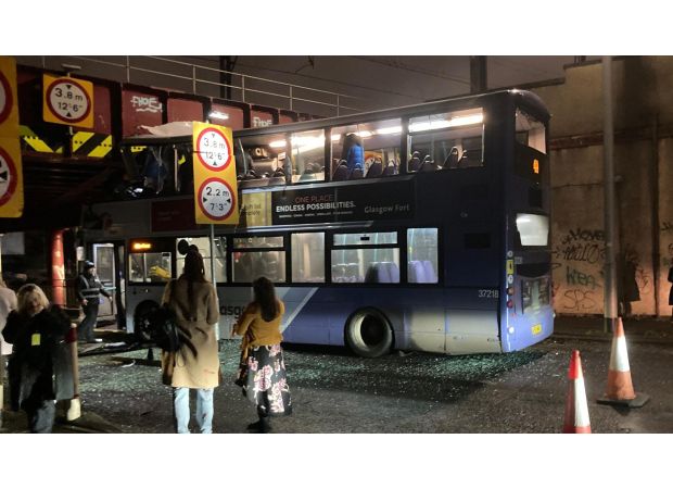 A bus passenger is critically injured after a double-decker bus crashes into a bridge.