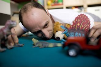 A 40-year-old man receives kids' toys as Christmas gifts from his spouse.