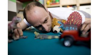 A 40-year-old man receives kids' toys as Christmas gifts from his spouse.