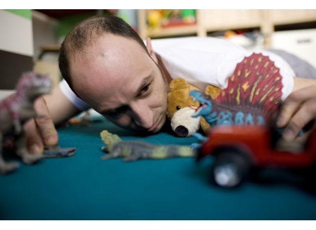 A 40-year-old man receives kids' toys as Christmas gifts from his spouse.