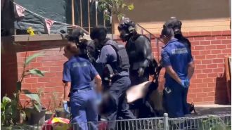 A man and woman were taken hostage in a machete attack on the Mid North coast of New South Wales.