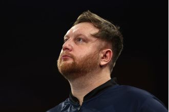 Darts player Cameron Menzies emotional after unexpected loss at World Championship.