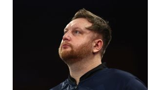 Darts player Cameron Menzies emotional after unexpected loss at World Championship.