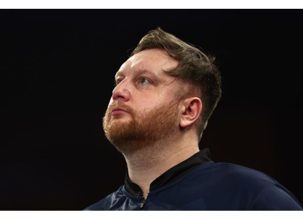 Darts player Cameron Menzies emotional after unexpected loss at World Championship.