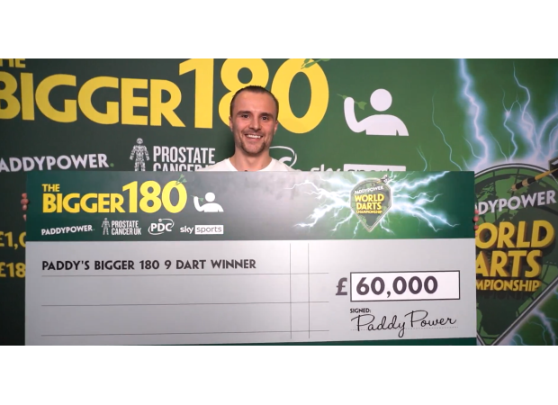 Fan ecstatic after scoring £60,000 for 9-dart finish at Darts Championship.