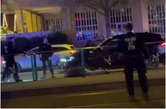 Suspect apprehended after car drives into crowded holiday market.