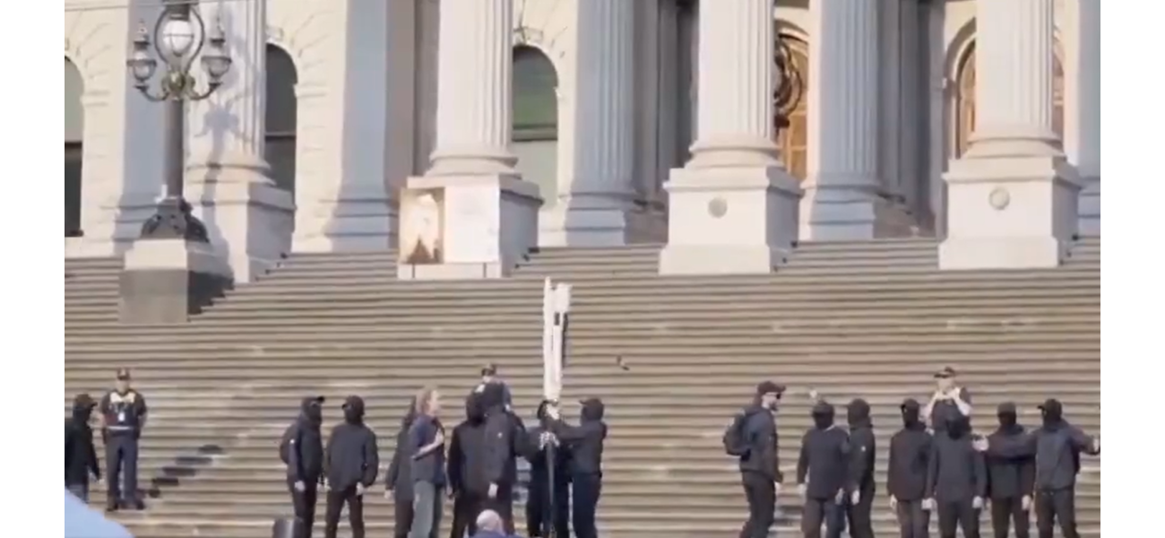 Neo-Nazis reveal offensive banner outside Victorian parliament.