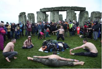Crowds flock to Stonehenge for ancient ritual with a long history.