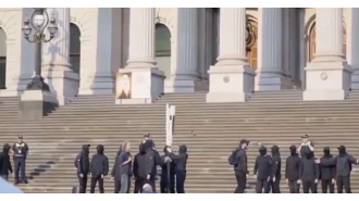 Neo-Nazis reveal offensive banner outside Victorian parliament.