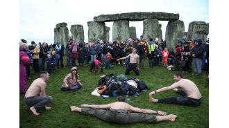 Crowds flock to Stonehenge for ancient ritual with a long history.