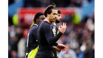 Grealish responds to taunting Villa fans with gesture during Man City loss.