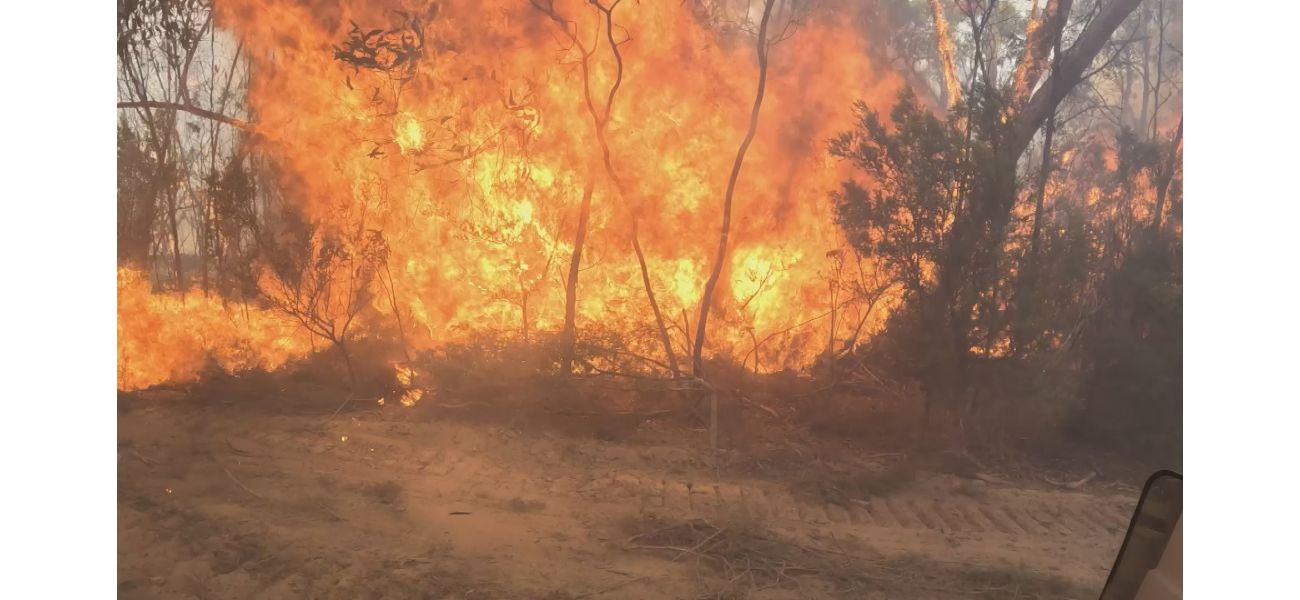 People leave their homes while a fire continues to rage in the north-west area of Melbourne.