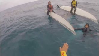 Three people saved after boat capsizes off coast of New South Wales.