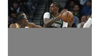 Warriors, led by Curry, defeat Timberwolves on the road with strong defense.