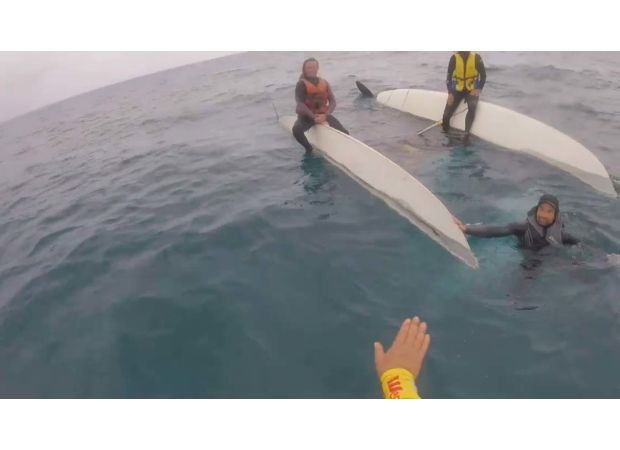 Three people saved after boat capsizes off coast of New South Wales.