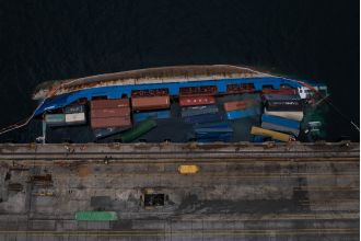 A 5,215-ton cargo ship tips over, causing the crew to escape for safety.