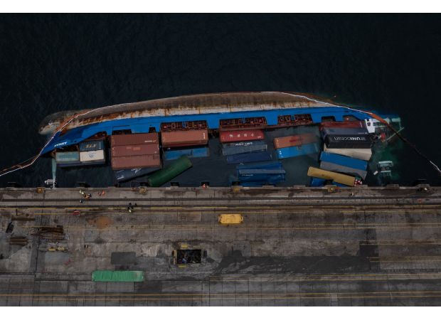 A 5,215-ton cargo ship tips over, causing the crew to escape for safety.