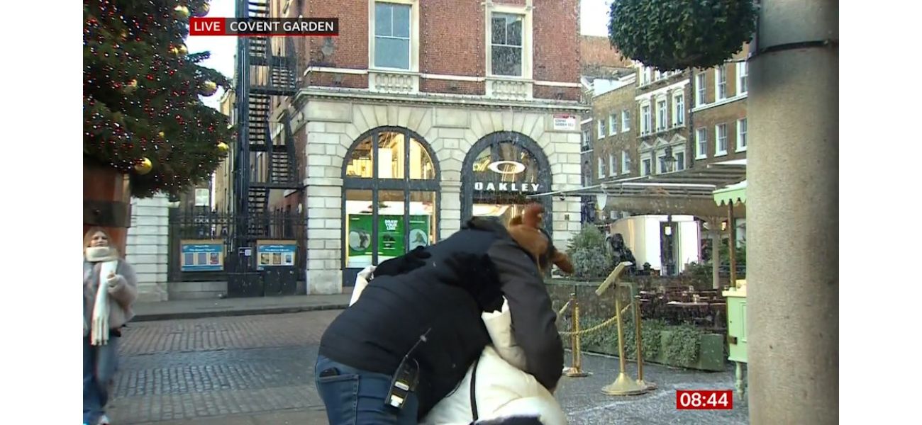 Carol Kirkwood calms audience after surprise on-air kiss from man.