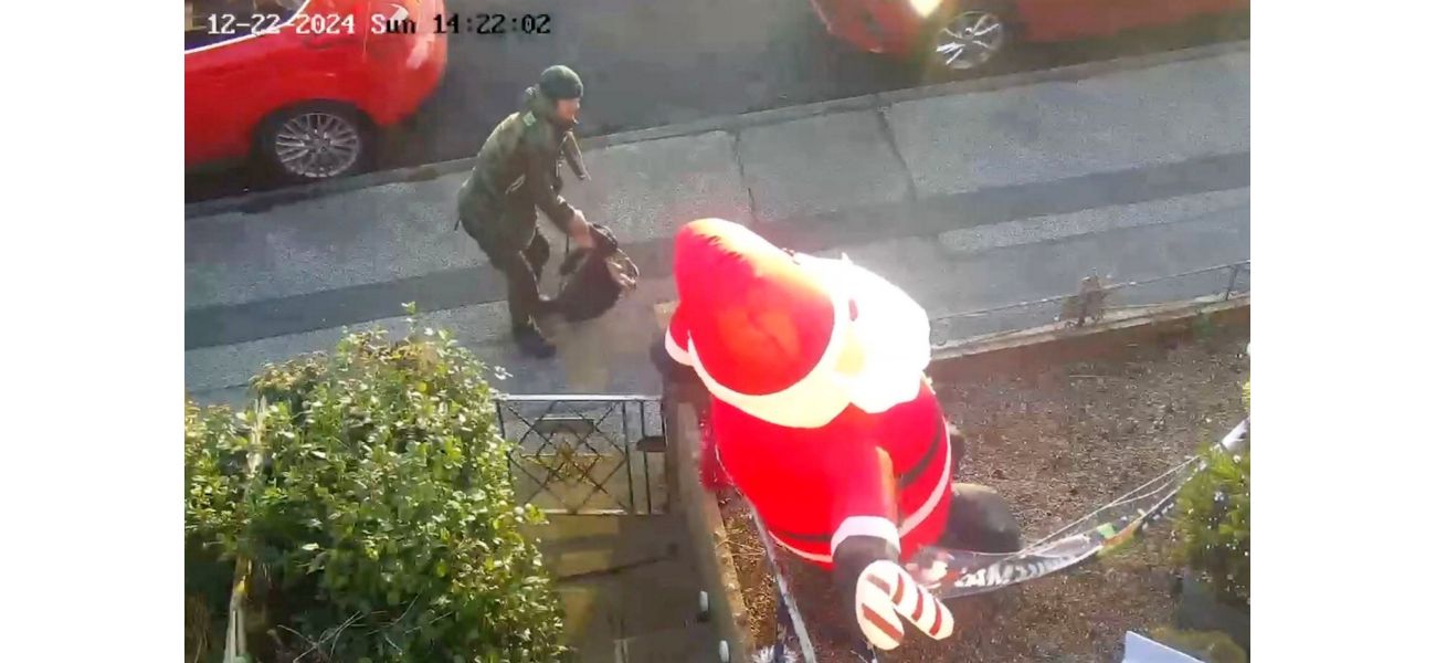 A person known as a 'real-life Grinch' was caught stabbing an inflatable Santa in front of a house.