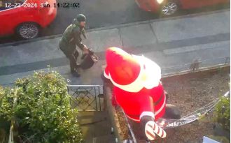 A person known as a 'real-life Grinch' was caught stabbing an inflatable Santa in front of a house.