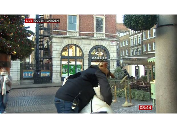 Carol Kirkwood calms audience after surprise on-air kiss from man.