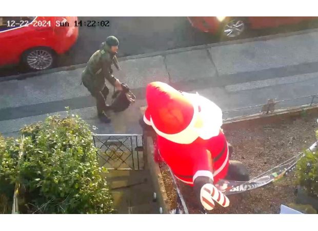A person known as a 'real-life Grinch' was caught stabbing an inflatable Santa in front of a house.