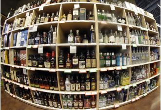 Neighborhood liquor shops file lawsuit against Colorado, alleging that state licenses are biased towards large retail chains such as Costco, Walmart, and Target.