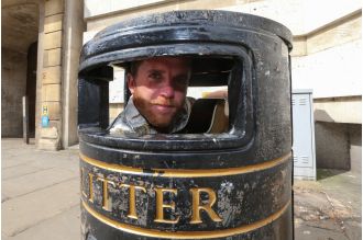 A tale of a 5ft 9 busker who fits himself inside a bin with his guitar.