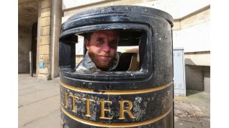 A tale of a 5ft 9 busker who fits himself inside a bin with his guitar.